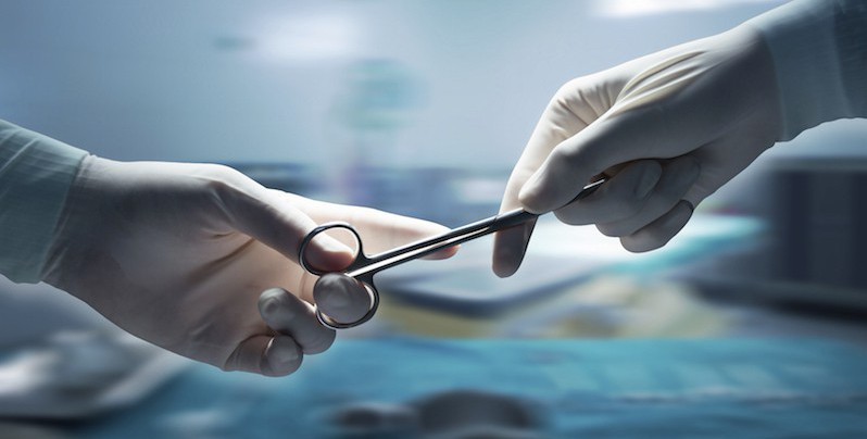 healthcare and medical concept , Close-up of surgeons hands holding surgical scissors and passing surgical equipment , motion blur background.